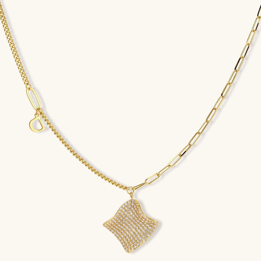 Gold-plated wavy jewelry set with crystal detailing featuring necklace with dual chains and matching textured earrings