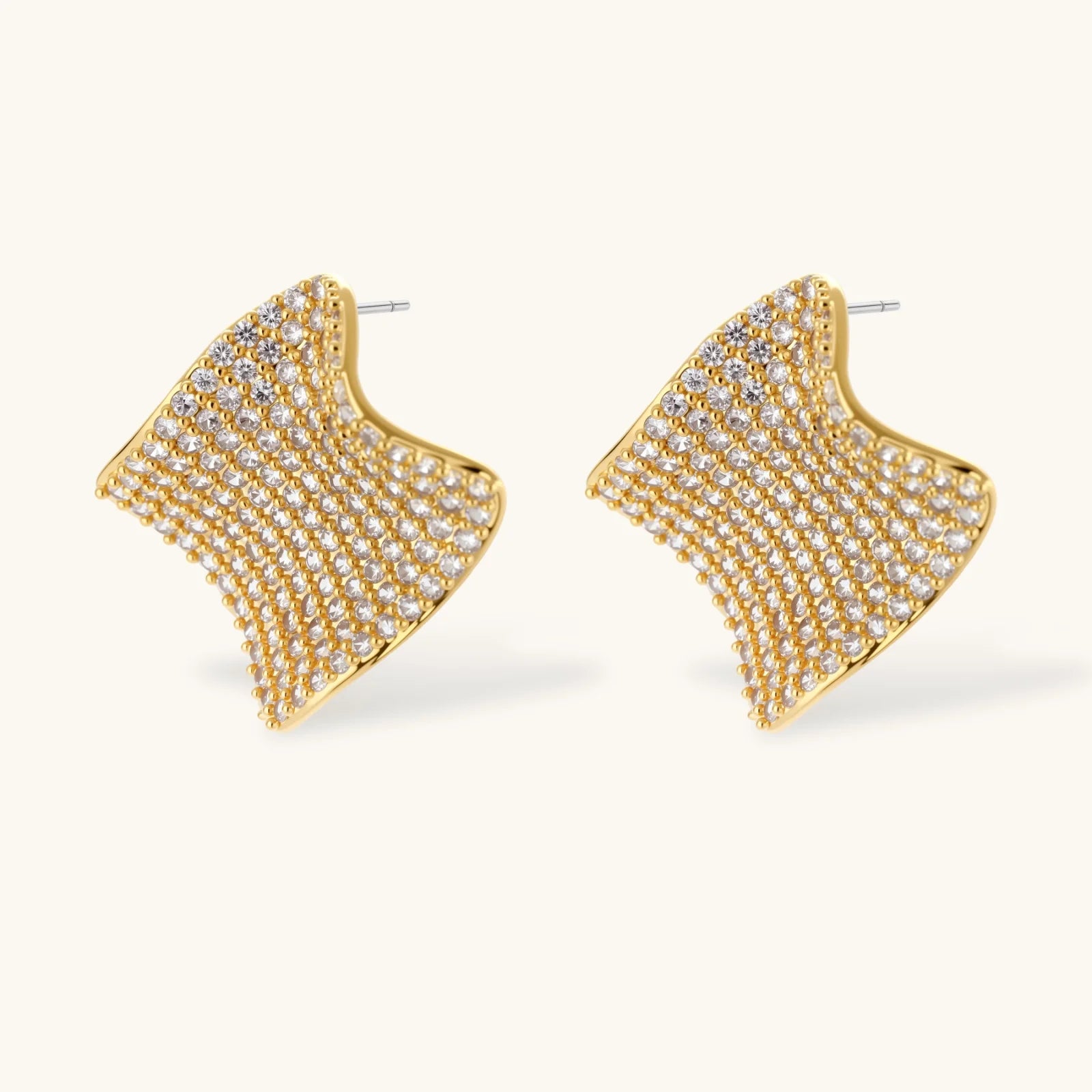Gold-plated wavy jewelry set with crystal detailing featuring necklace with dual chains and matching textured earrings