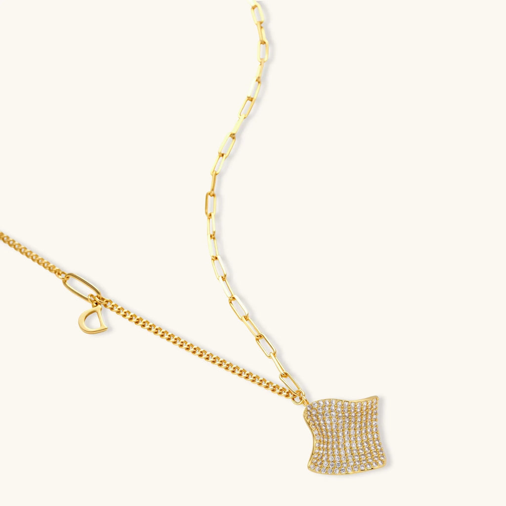 Gold-plated wavy jewelry set with crystal detailing featuring necklace with dual chains and matching textured earrings