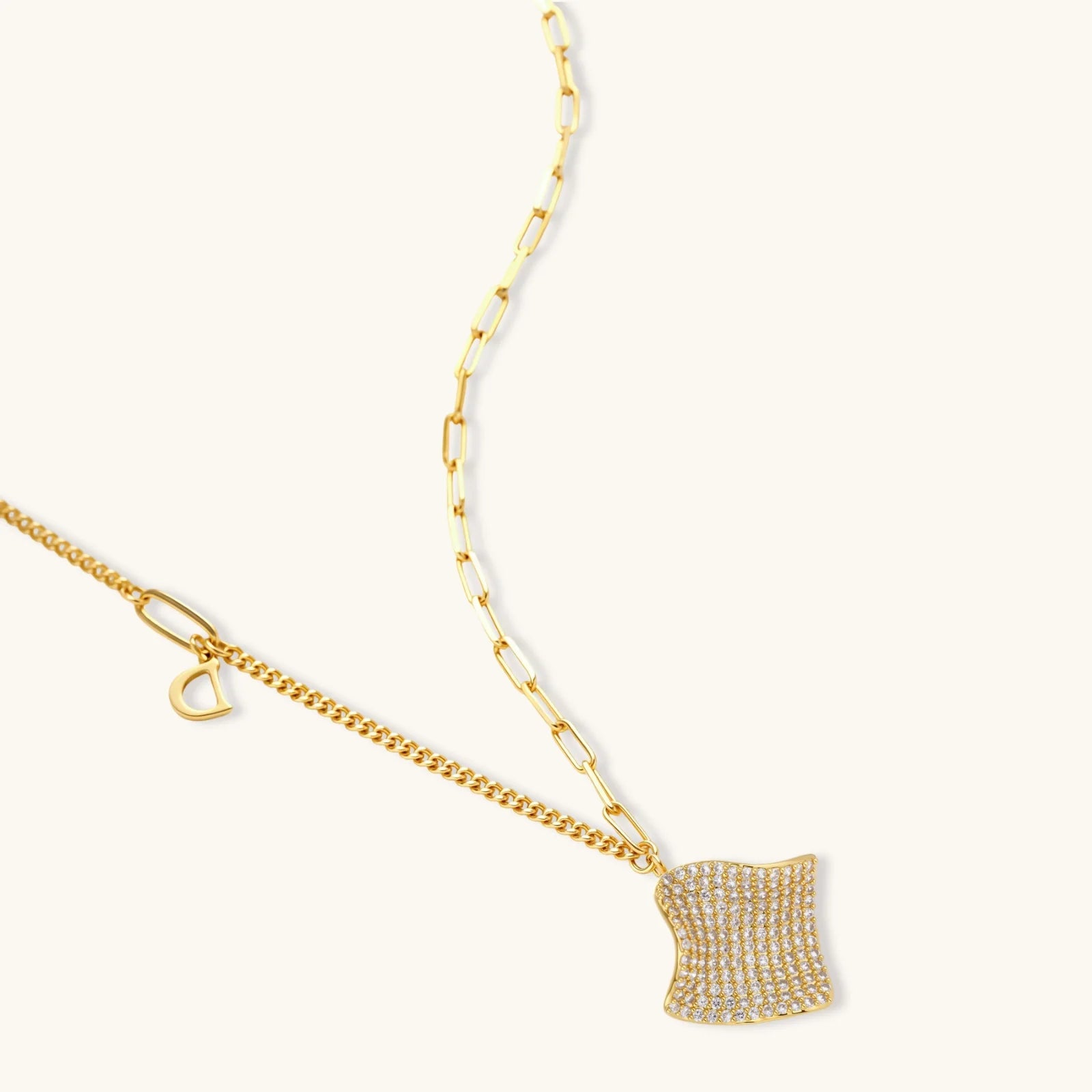 Gold-plated wavy jewelry set with crystal detailing featuring necklace with dual chains and matching textured earrings