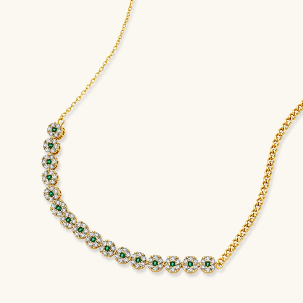 Gold-plated jewelry set with green cubic zirconia floral motifs, featuring matching necklace and pearl drop earrings