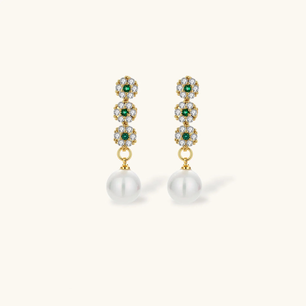 Gold-plated jewelry set with green cubic zirconia floral motifs, featuring matching necklace and pearl drop earrings