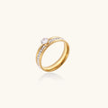 Gold-plated double-band ring with center rhinestone solitaire and channel-set stones on white background