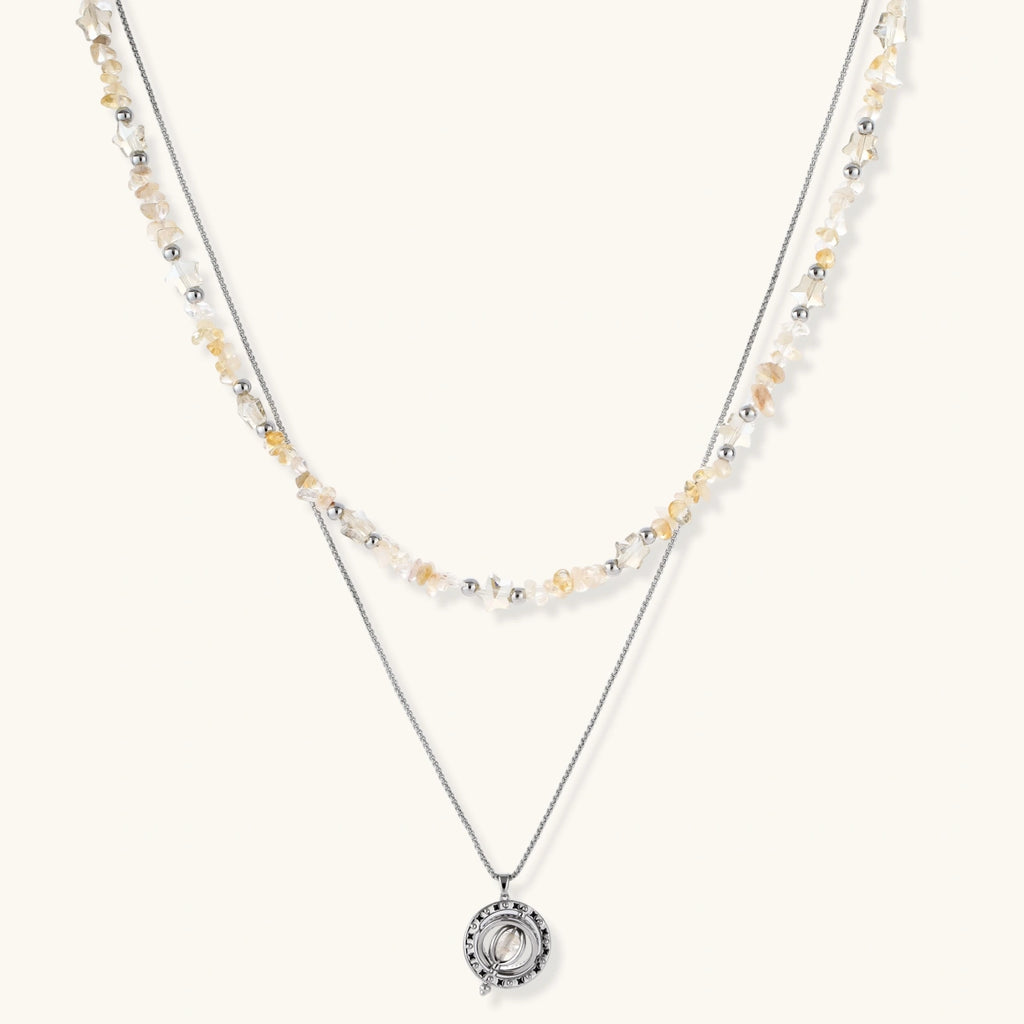 Complete jewelry set featuring citrine stone chips, silver beads, and cosmic circle pendants on cream background.